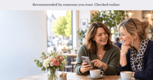 Two people discussing a recommended local business over coffee.